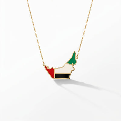 UAE map necklace in 18K gold with UAE flag enamel fill — red, white, black and green — by ROKO Jewelers Dubai