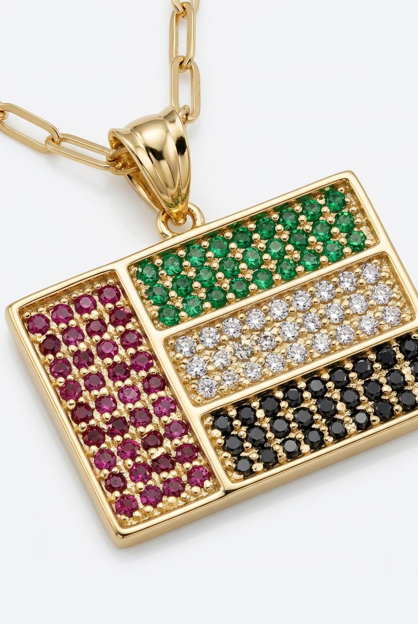 Gold pendant with gemstones on a white background