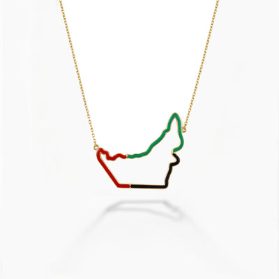 Necklace with a pendant shaped like the flag of the United Arab Emirates on a white background