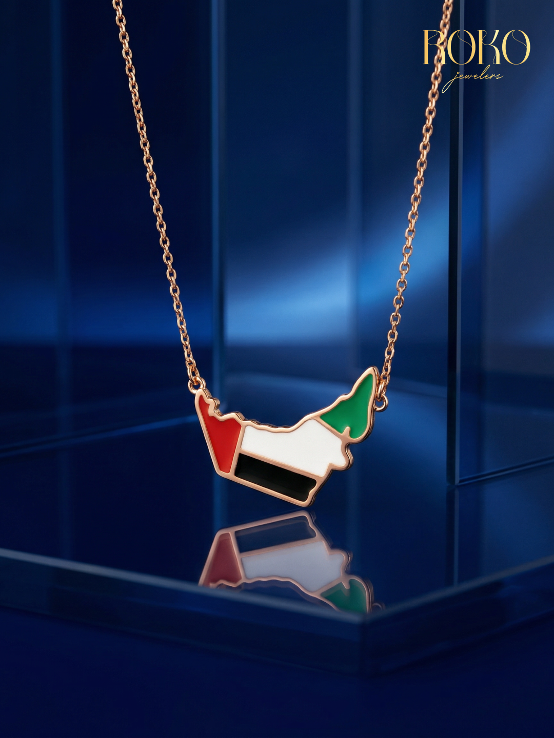 Necklace with a pendant shaped like the United Arab Emirates flag on a blue background