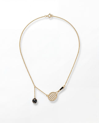 Gold necklace with a tennis racket and ball pendant on a white background
