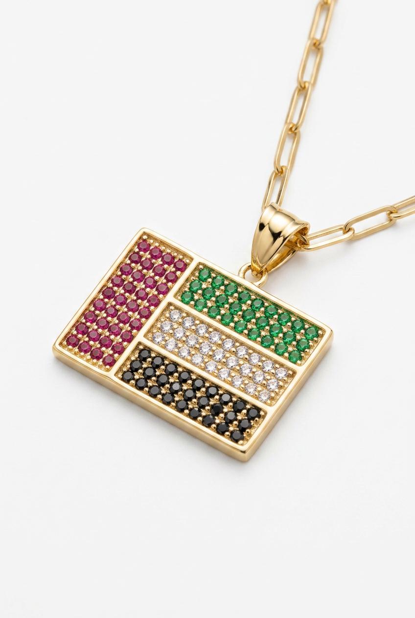 UAE map gold necklace close up with red green black stones